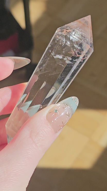 Rainbow clear quartz Vogel on a stand